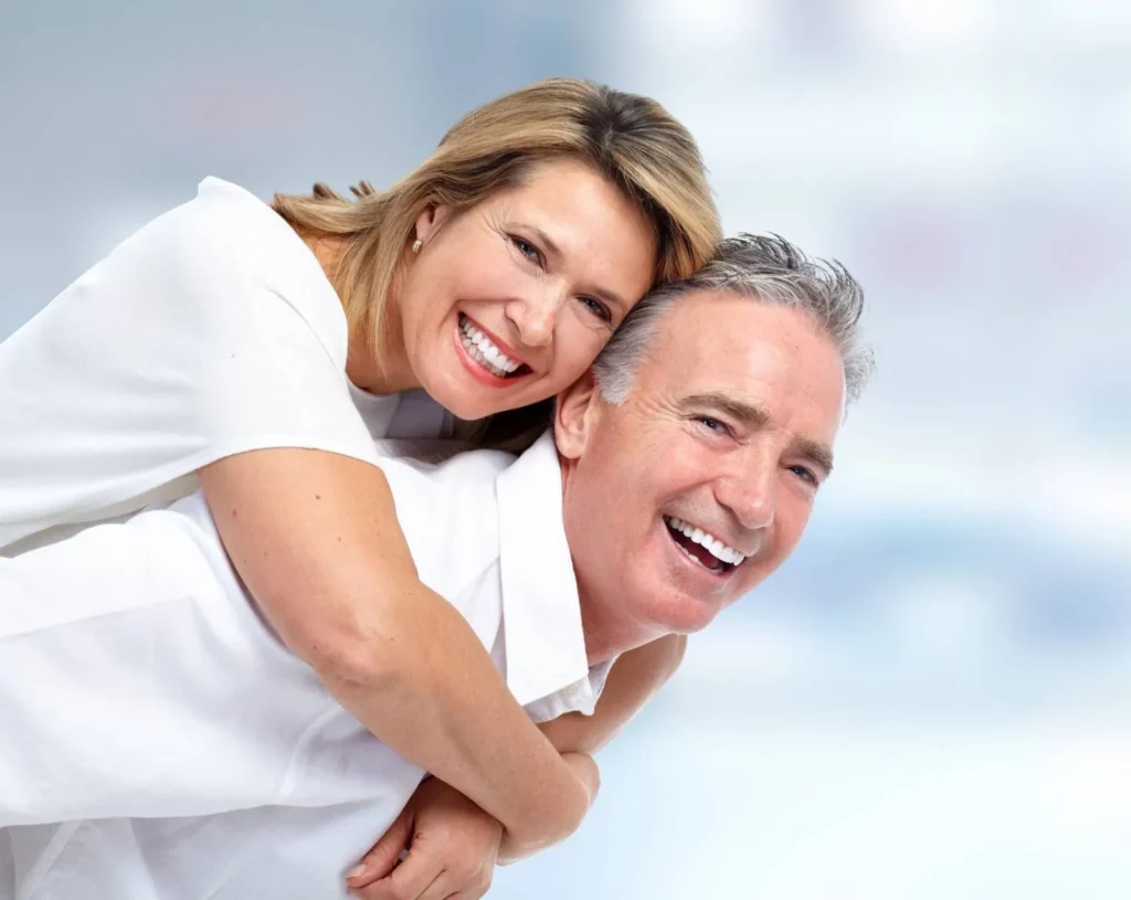 Couple senior souriant et enlacé illustrant la prévoyance et l'assurance obsèques