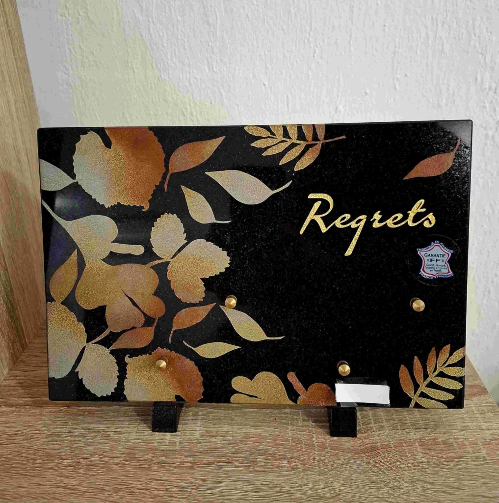 Plaque funéraire rectangulaire en granit noir avec motifs de feuillage d'automne et inscription Regrets